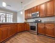 Williamsburg apartment for rent - A kitchen with wooden cabinets and a stainless steel oven  at Sterling Manor, Williamsburg, Virginia