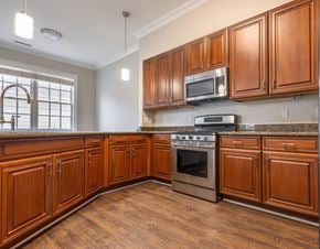 Williamsburg apartment for rent - A kitchen with wooden cabinets and a stainless steel oven  at Sterling Manor, Williamsburg, Virginia