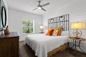 Asheville apartment for rent - a bedroom with a bed and a ceiling fan