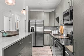 Asheville apartment for rent - a kitchen with stainless steel appliances and white counter tops