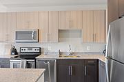 Woodbridge apartment for rent - a kitchen with wooden cabinets and granite countertops at Rivergate, Woodbridge
