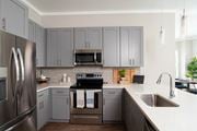 Chattanooga apartment for rent - a kitchen with stainless steel appliances and white cabinets at One Riverside Apartments, Tennessee, 37403