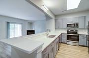 Virginia Beach apartment for rent - A modern kitchen with a white countertop and stainless steel appliances.