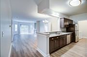 Virginia Beach apartment for rent - A kitchen with dark wood cabinets and a white island.