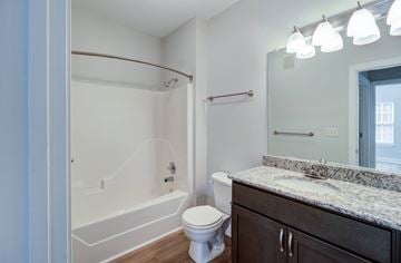 Virginia Beach apartment for rent - A bathroom with a toilet, sink, and tub.
