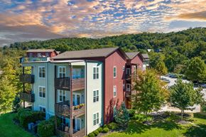 Asheville apartment for rent - an aerial view of a building with a mountain in the background