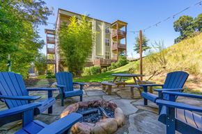 Asheville apartment for rent - a patio with blue chairs and a fire pit     and a building