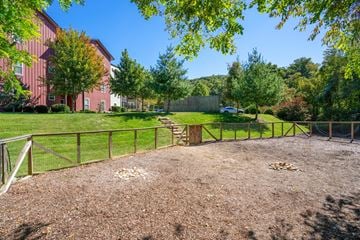 Asheville apartment for rent - A playground with a brown surface and a fence surrounding it.