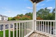 Gainesville apartment for rent - a balcony with a view of a parking lot and trees at SomerHill Farms Apartments, Gainesville, VA