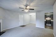 Warner Robins apartment for rent - A spacious room with a ceiling fan and a fireplace.