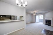 Warner Robins apartment for rent - A living room with a fireplace and a ceiling fan.