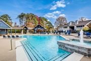 Warner Robins apartment for rent - A large swimming pool with a fountain in the middle of it.