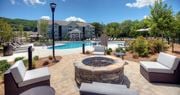 Hixson apartment for rent - an outdoor patio with a fire pit and a swimming pool  at Lullwater at Big Ridge, Tennessee, 37343