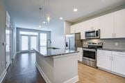 Lawrenceville apartment for rent - A kitchen with white cabinets and a granite countertop.