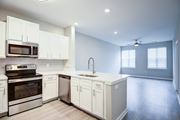 Glen Allen apartment for rent - A modern kitchen with white cabinets and stainless steel appliances.