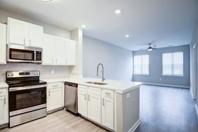 Glen Allen apartment for rent - A modern kitchen with white cabinets and stainless steel appliances.