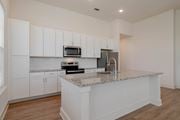 Acworth apartment for rent - A kitchen with white cabinets and a granite countertop.