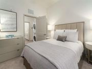 Midlothian apartment for rent - a bedroom with a bed and a washer and dryer at Artistry at Winterfield Apartments, Midlothian, VA, 23112