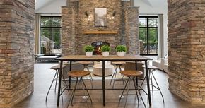 Richmond apartment for rent - a dining room with a table and chairs and a fireplace in the background at Trails at Short Pump Apartments, Richmond ,23233