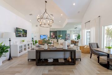 Parkland apartment for rent - A modern living room with a white sofa set and a chandelier.