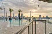 Jacksonville apartment for rent - the swimming pool on the roof of a building with the city skyline in the background at Vista Brooklynn Apartments, Florida