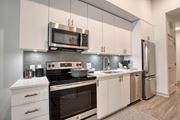 Jacksonville apartment for rent - a kitchen with stainless steel appliances and white cabinets at Vista Brooklynn Apartments, Jacksonville, FL, 32202