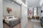 Jacksonville apartment for rent - a bedroom with a bed and a living room with a dining room at Vista Brooklynn Apartments, Jacksonville, Florida