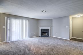 Augusta apartment for rent - A living room with a fireplace and carpeted floor.