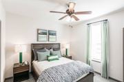 Knoxville apartment for rent - a bedroom with a bed and a ceiling fan at Village at Westland Cove Apartments, Knoxville, 37922