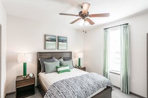 Knoxville apartment for rent - a bedroom with a bed and a ceiling fan at Village at Westland Cove Apartments, Knoxville, 37922