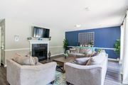 Aiken apartment for rent - A living room with a fireplace and two grey chairs.