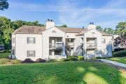 Aiken apartment for rent - A large, two-story house with a white exterior and a balcony on the second floor.
