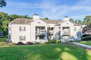 Aiken apartment for rent - A large, two-story house with a white exterior and a balcony on the second floor.
