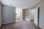 Aiken apartment for rent - A room with a carpeted floor and a doorway leading to another room.