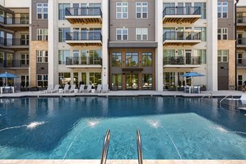 Chester apartment for rent - A large swimming pool in front of a multi-story apartment building.