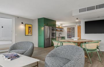Chicago apartment for rent - A living room with a grey chair and a white table.