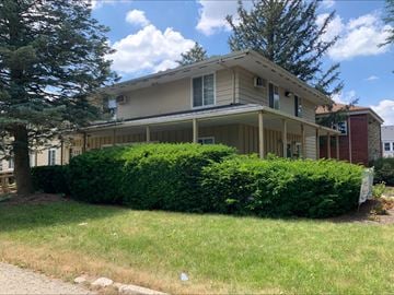 Dekalb apartment for rent - A house with a well-maintained green lawn in front.