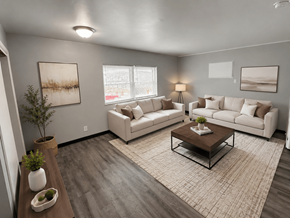 Columbus apartment for rent - A living room with a white couch, a coffee table, and a plant.