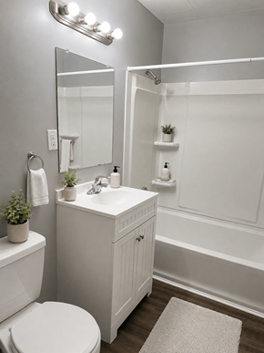 Columbus apartment for rent - A white bathroom with a toilet, sink, and mirror.
