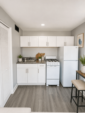 Columbus apartment for rent - A kitchen with white cabinets and a white refrigerator.