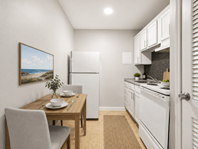 Bexley apartment for rent - A kitchen with a table and chairs in front of a painting of a beach scene.