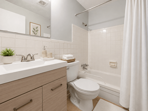 Columbus apartment for rent - A white bathroom with a toilet, sink, and bathtub.