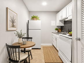 Columbus apartment for rent - A kitchen with a table and chairs and a fridge.