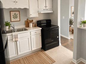 Dekalb apartment for rent - Kitchen with white cabinets and black appliances at The Terraces at Dekalb Apartments, Illinois