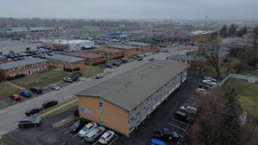 Columbus apartment for rent - A parking lot with a building in the middle.
