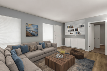 Shreveport apartment for rent - A living room with a grey couch, a brown coffee table, and a painting on the wall.