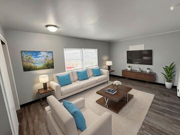 Columbus apartment for rent - A living room with a white couch, a coffee table, and a painting on the wall.