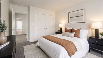 Washington apartment for rent - A bedroom with a large bed and a painting on the wall.