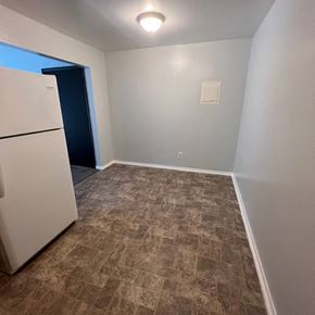 Dekalb apartment for rent - A room with a tiled floor and a white refrigerator.