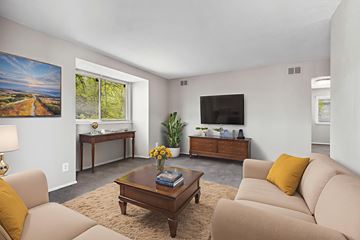 Tuscaloosa apartment for rent - A living room with a brown coffee table and beige couches.